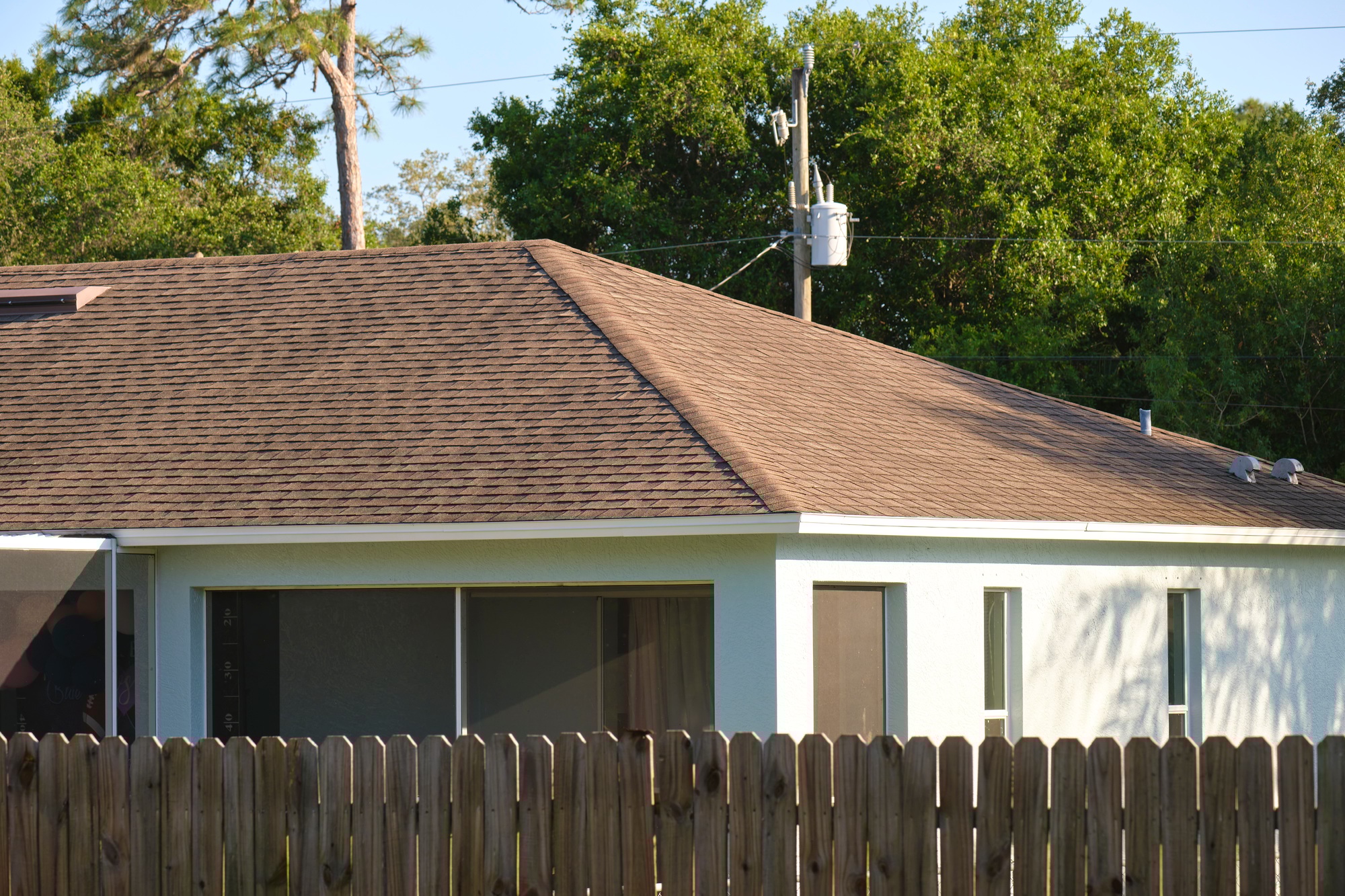 Closeup of house roof top covered with asphalt or bitumen shingles. Waterproofing of new building