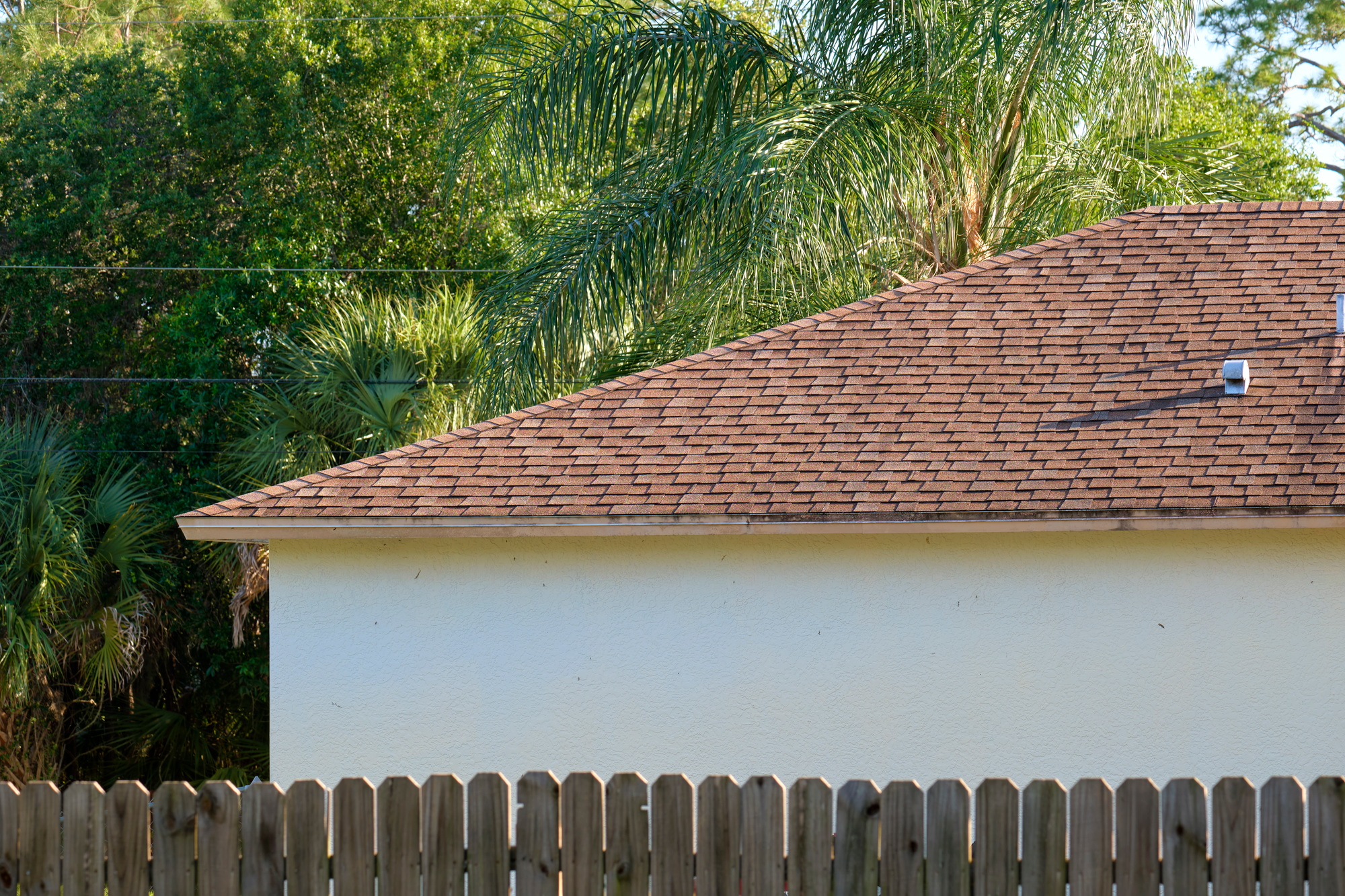 Closeup of house roof top covered with asphalt or bitumen shingles. Waterproofing of new building